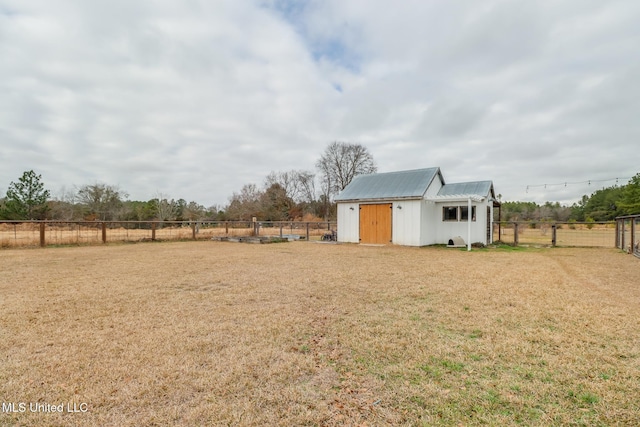 view of yard featuring a rural view and a storage unit