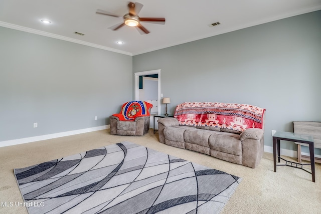 carpeted living room with ceiling fan and ornamental molding