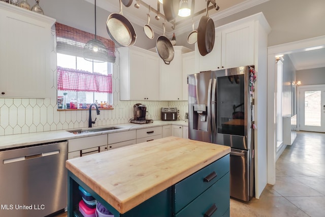 kitchen with white cabinetry, sink, stainless steel appliances, and a center island