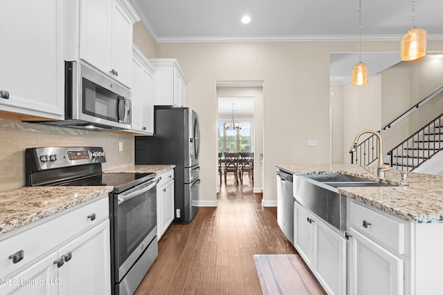 5110 Kensington Creek Dr, Southaven, MS 38672 - kitchen with stainless steel appliances, white cabinets, backsplash, a chandelier, and recessed lighting