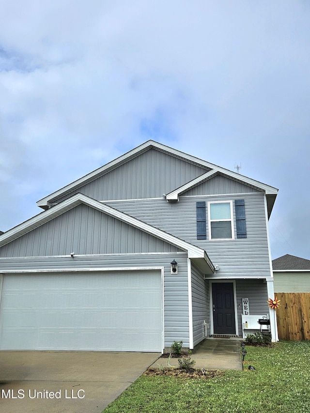2205 Magazine St, Ocean Springs, MS 39564 - view of front of property featuring an attached garage, board and batten siding, and driveway