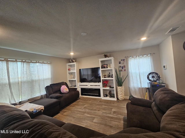 2205 Magazine St, Ocean Springs, MS 39564 - living room featuring healthy amount of natural light, wood finished floors, recessed lighting, and a textured ceiling