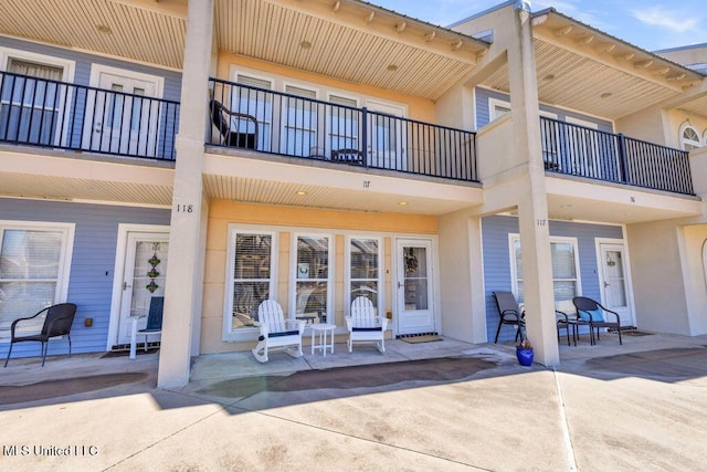 rear view of property featuring stucco siding