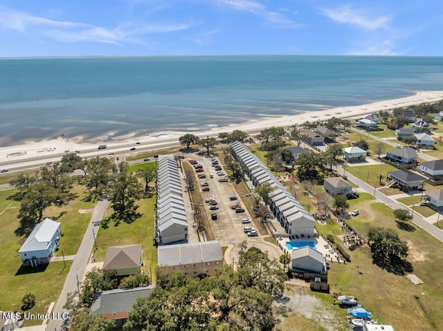 birds eye view of property featuring a water view and a beach view