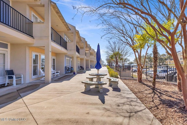 surrounding community featuring a patio and fence