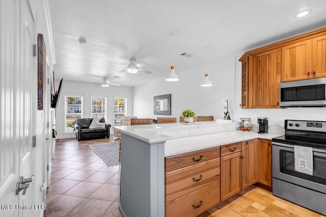 kitchen featuring stainless steel appliances, a peninsula, visible vents, open floor plan, and hanging light fixtures