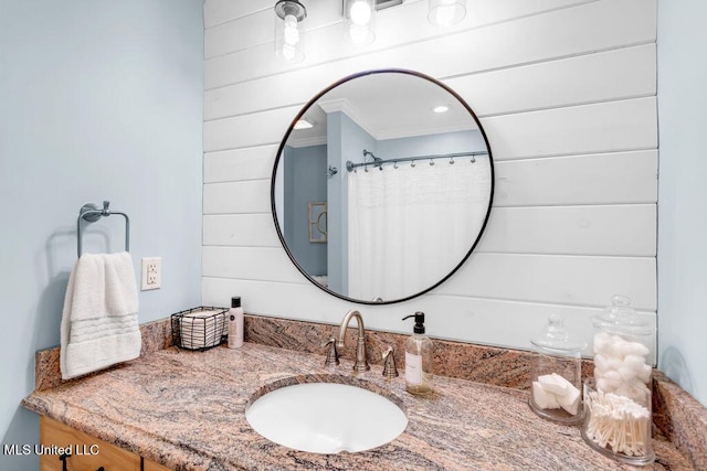 bathroom featuring wood walls and vanity