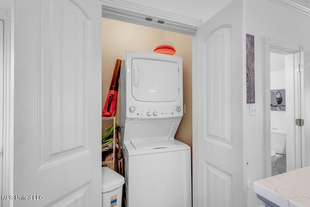 laundry room featuring laundry area and stacked washer and clothes dryer