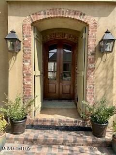 entrance to property with french doors and brick siding