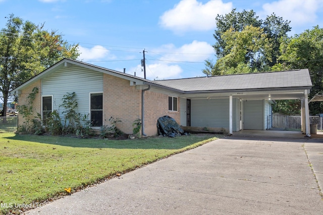 view of side of home with a lawn and a carport