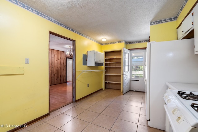 kitchen featuring light hardwood / wood-style flooring, white cabinetry, a textured ceiling, and white range oven