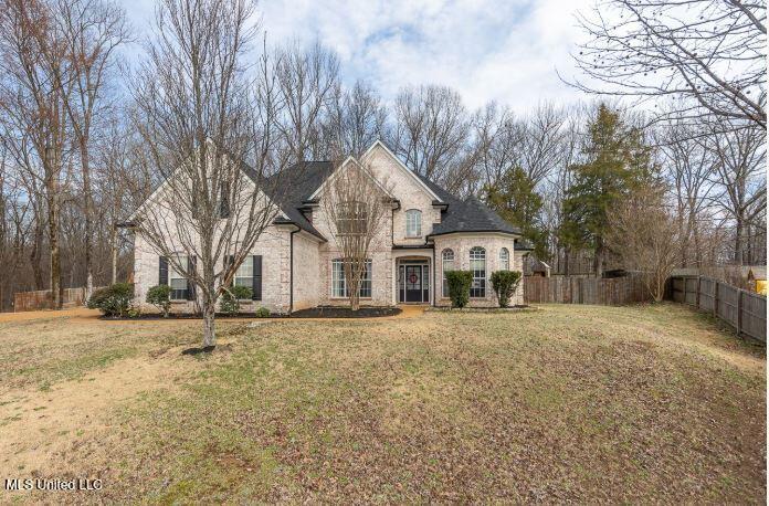 french country inspired facade with a front lawn