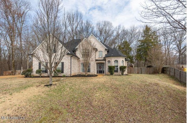 french country home with a front lawn