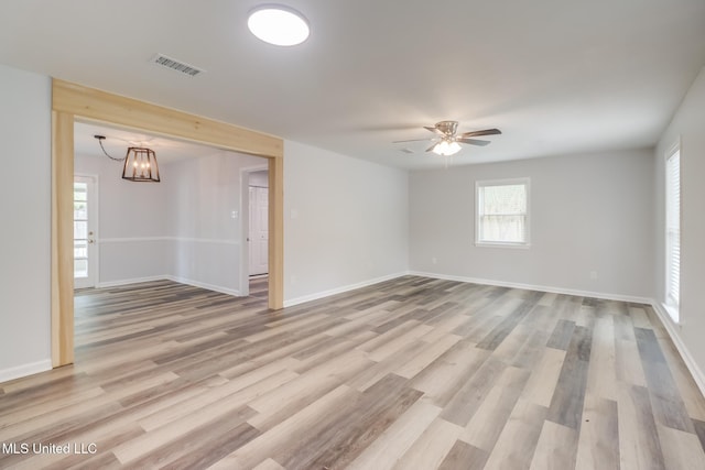 12082 Marlane Pl, Gulfport, MS 39503 - empty room featuring light wood-style flooring, ceiling fan with notable chandelier, baseboards, and visible vents