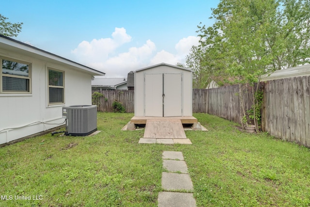 12082 Marlane Pl, Gulfport, MS 39503 - view of yard featuring an outdoor structure, a storage unit, a fenced backyard, and central AC
