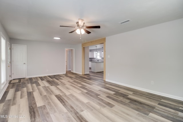 12082 Marlane Pl, Gulfport, MS 39503 - spare room with baseboards, visible vents, wood finished floors, and a ceiling fan