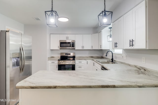 12082 Marlane Pl, Gulfport, MS 39503 - kitchen with white cabinets, light stone counters, a sink, and stainless steel appliances