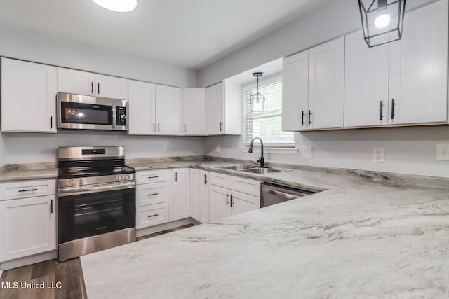 12082 Marlane Pl, Gulfport, MS 39503 - kitchen featuring light stone countertops, white cabinets, a sink, and stainless steel appliances