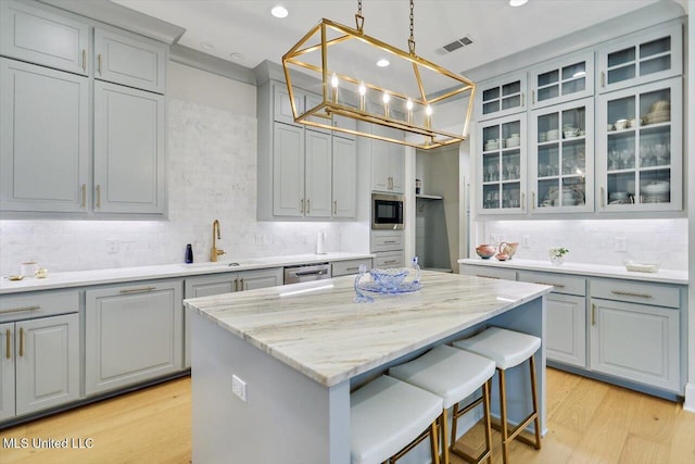 122 Seymour Dr, Madison, MS 39110 - kitchen with gray cabinetry, appliances with stainless steel finishes, tasteful backsplash, a kitchen island, and recessed lighting