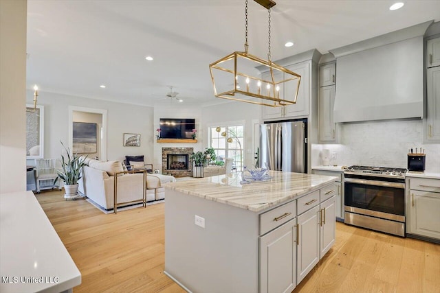 122 Seymour Dr, Madison, MS 39110 - kitchen featuring appliances with stainless steel finishes, ceiling fan, a center island, recessed lighting, and light wood-type flooring