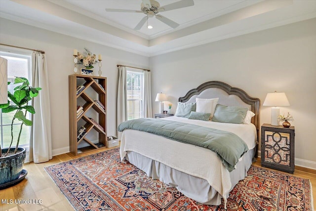 122 Seymour Dr, Madison, MS 39110 - bedroom featuring multiple windows, a raised ceiling, light wood-style flooring, ornamental molding, and baseboards