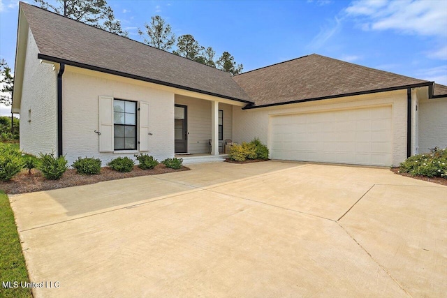 122 Seymour Dr, Madison, MS 39110 - view of front of house with driveway, a garage, and a shingled roof