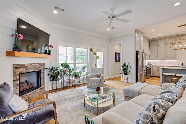 122 Seymour Dr, Madison, MS 39110 - living room featuring crown molding, a ceiling fan, a chandelier, light wood finished floors, and recessed lighting