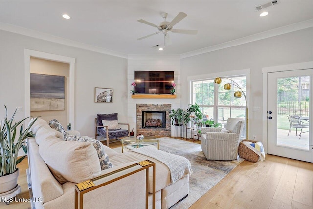122 Seymour Dr, Madison, MS 39110 - living area with light wood finished floors, healthy amount of natural light, a fireplace, ornamental molding, and a ceiling fan