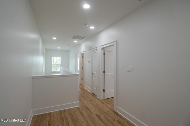 103 E 2nd St, Pass Christian, MS 39571 - hallway with visible vents, baseboards, light wood-type flooring, and recessed lighting