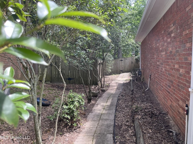 3057 Windwood Cir, Flowood, MS 39232 - view of side of home featuring a fenced backyard and brick siding