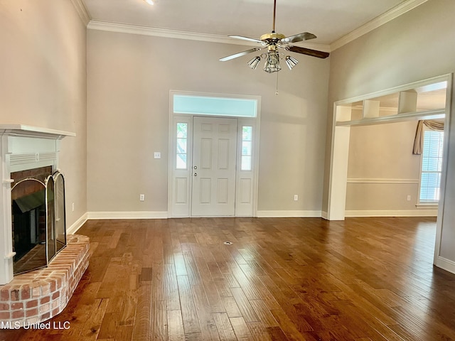 3057 Windwood Cir, Flowood, MS 39232 - entryway featuring a ceiling fan, crown molding, dark wood-type flooring, a fireplace, and baseboards
