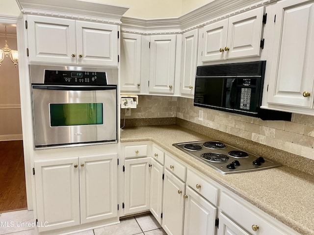 3057 Windwood Cir, Flowood, MS 39232 - kitchen with stainless steel appliances, white cabinetry, and backsplash