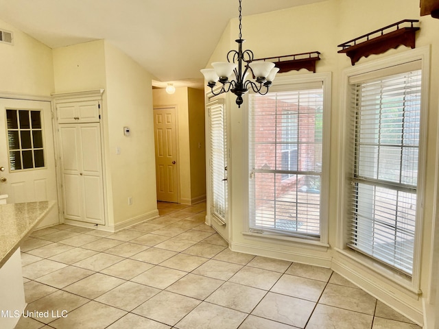 3057 Windwood Cir, Flowood, MS 39232 - unfurnished dining area with light tile patterned floors, a chandelier, lofted ceiling, and baseboards