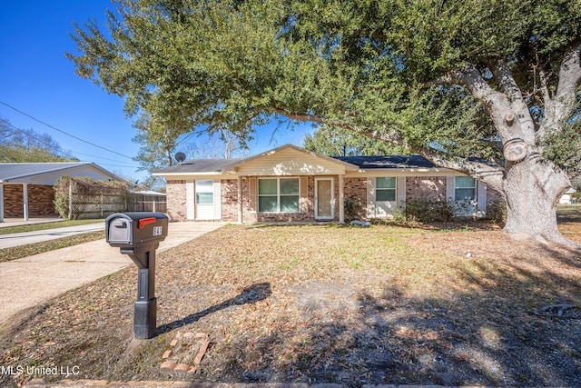 ranch-style home with brick siding and fence