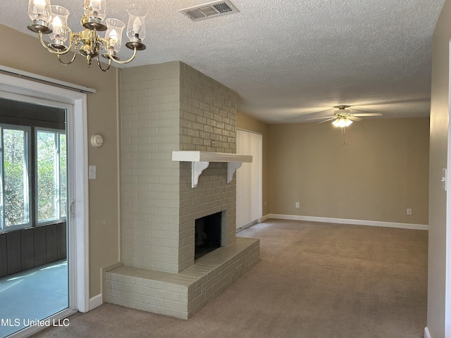 unfurnished living room with a textured ceiling, light carpet, ceiling fan with notable chandelier, visible vents, and a brick fireplace