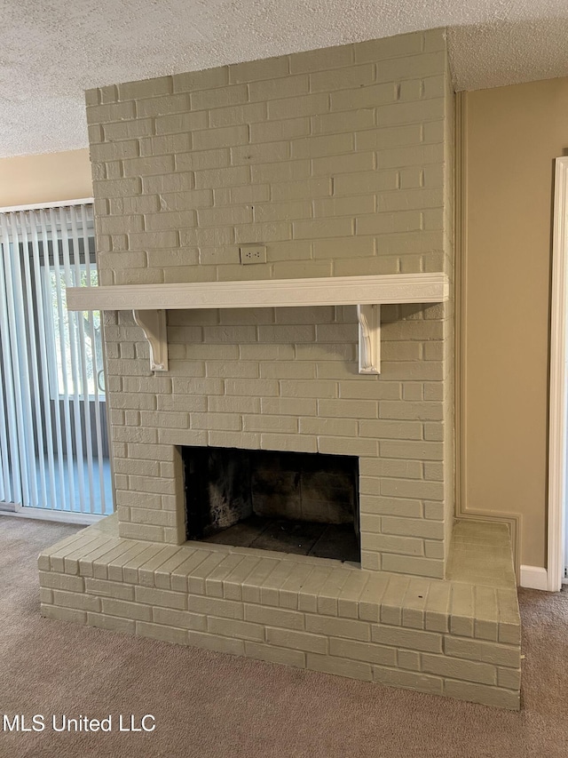 details featuring a brick fireplace, a textured ceiling, and carpet flooring