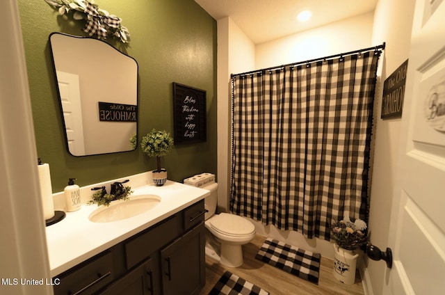 full bathroom featuring vanity, toilet, and wood finished floors