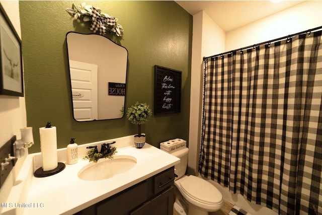 bathroom with toilet and vanity