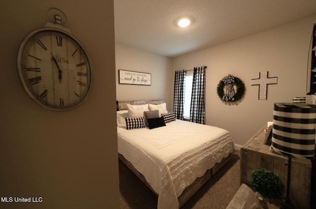 bedroom with baseboards and carpet