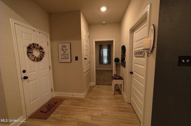 doorway featuring recessed lighting, baseboards, and light wood finished floors