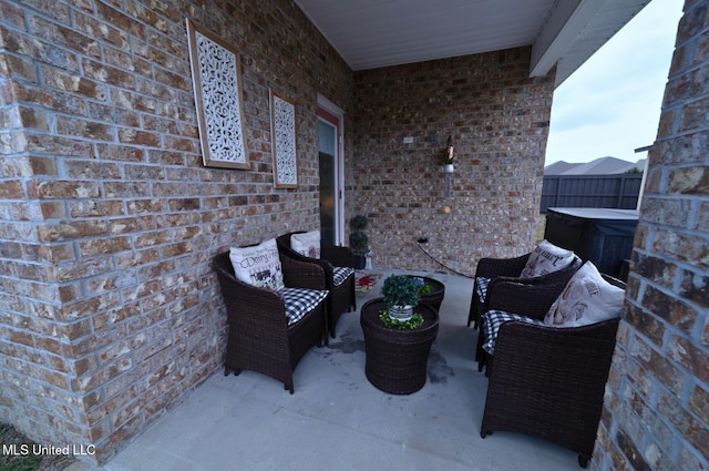 view of patio / terrace with a hot tub and outdoor lounge area