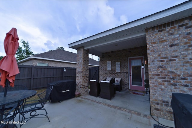 view of patio with a fenced backyard, outdoor dining space, and a grill