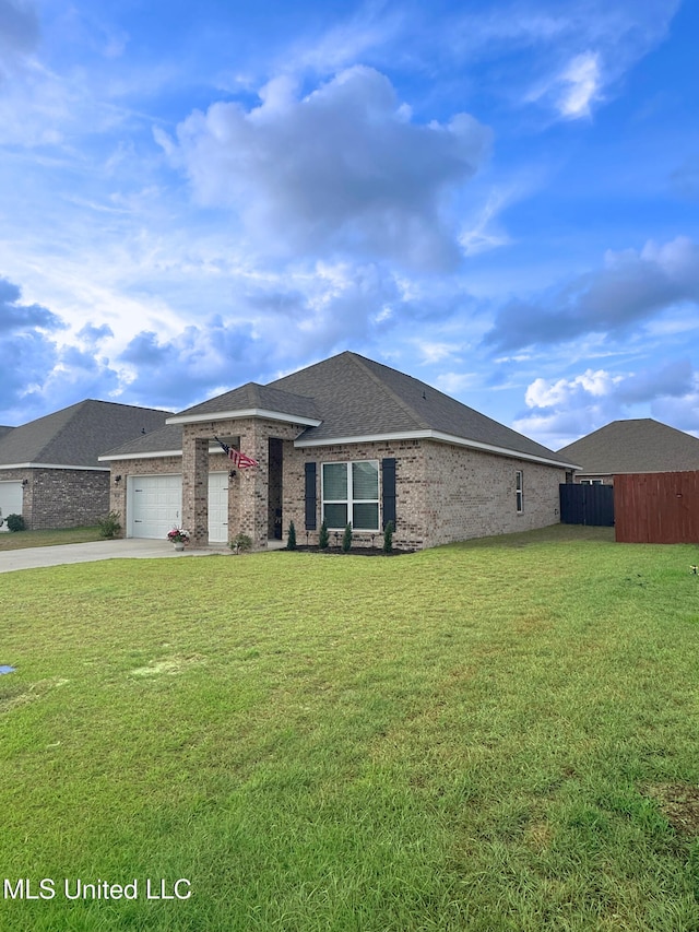 view of front of house featuring an attached garage, driveway, brick siding, and a front yard
