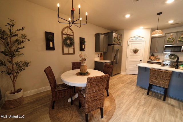 dining room featuring visible vents, light wood-type flooring, baseboards, a notable chandelier, and recessed lighting