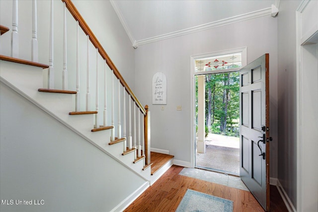 6193 Spring Hill Dr, Olive Branch, MS 38654 - entrance foyer with crown molding, light wood-style flooring, and stairway