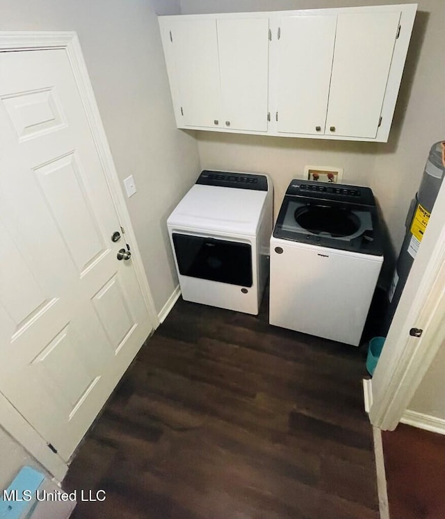 washroom featuring cabinets, dark wood-type flooring, and washing machine and clothes dryer