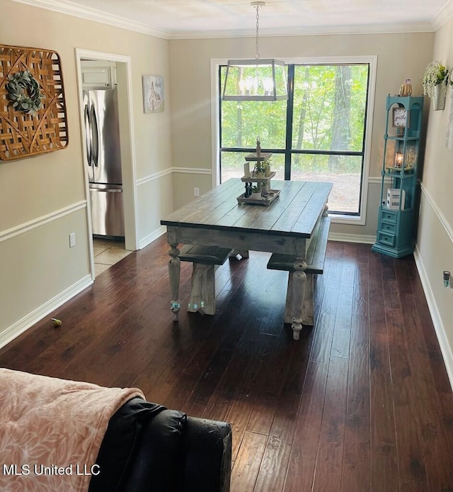 dining room with wood-type flooring and ornamental molding