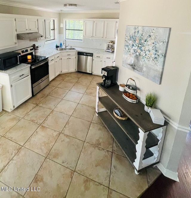 kitchen with light tile patterned floors, stainless steel appliances, crown molding, white cabinets, and sink