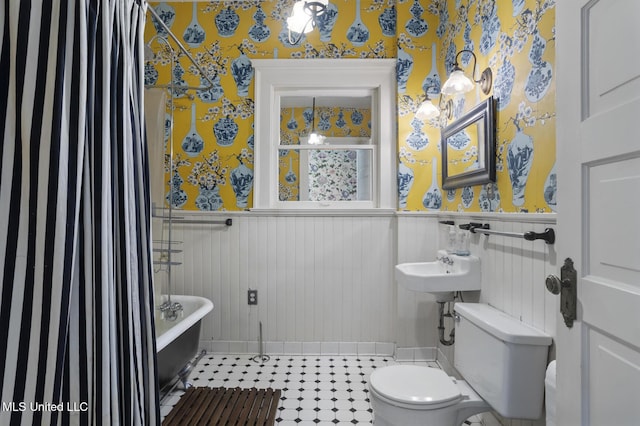 1704 N State St, Jackson, MS 39202 - full bath with wallpapered walls, wainscoting, a freestanding tub, and a shower with shower curtain