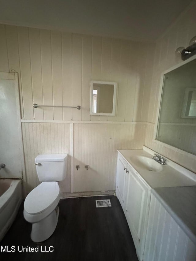 1870 Wisteria Dr, Jackson, MS 39204 - bathroom with vanity, toilet, wood finished floors, and wood walls